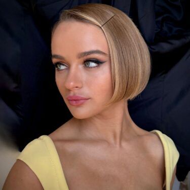 a woman looking over her shoulder with her hair in a short cropped bob hairstyle