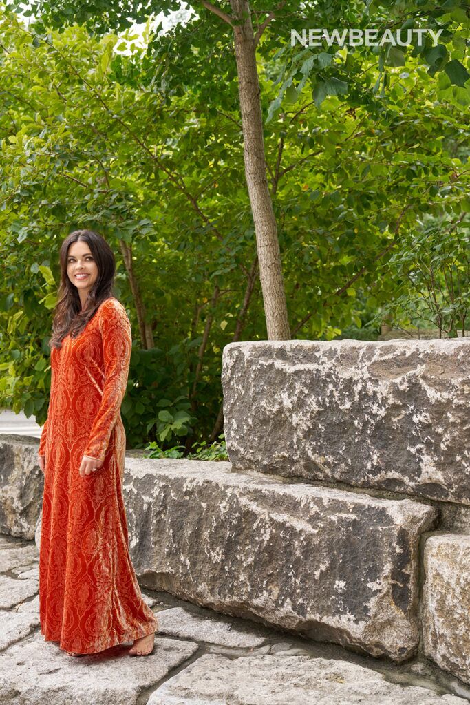 Katie Lee outdoors in full-length orange velvet dress