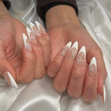 A classic French manicure with snowflake designs