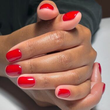 Short nails with a bright red nail polish