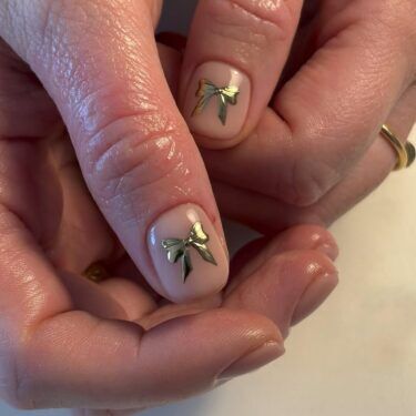 Manicure with gold foil bows