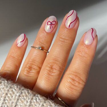 Short nails with red ribbon nail art