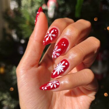 Long red nails with snowflake nail art