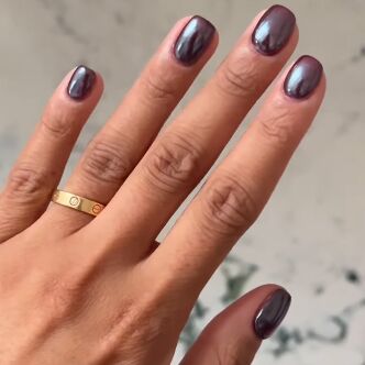 hand with purple chrome manicure