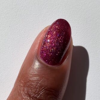 red-purple nail polish on finger