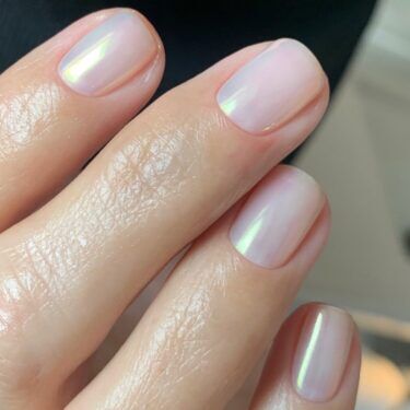 Short natural nails with chrome polish.