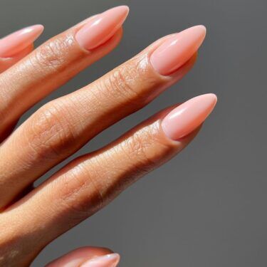 A plain manicure with sheer peach polish