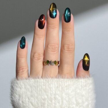 A manicure with colorful aura nail designs