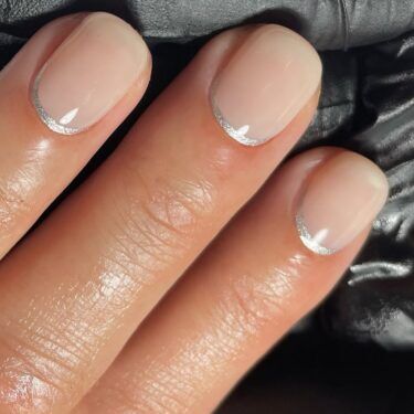 Short nails with silver reverse French manicure design