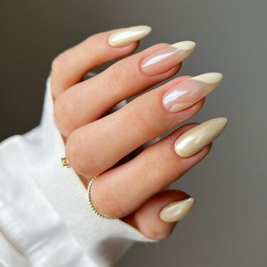 Long nails with cream-colored chrome polish