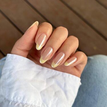 A French manicure with light lemon chrome tips