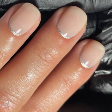 Short nails with silver reverse French manicure design