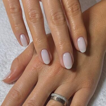 Medium-length round nails with milky white polish