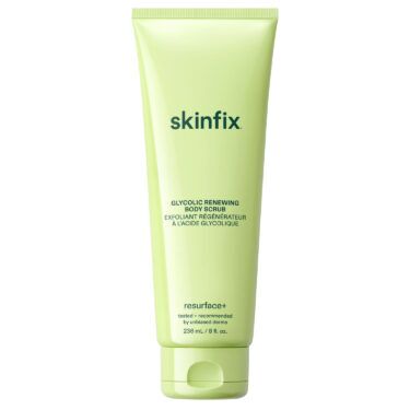 Skinfix Glycolic Renewing Body Scrub in a light green squeeze tube, a glycolic acid body exfoliator designed to smooth rough texture and brighten skin, featured in a roundup of the best body exfoliators.