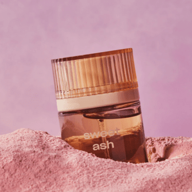 Bottle of Snif Sweet Ash Eau de Toilette staged on pink background