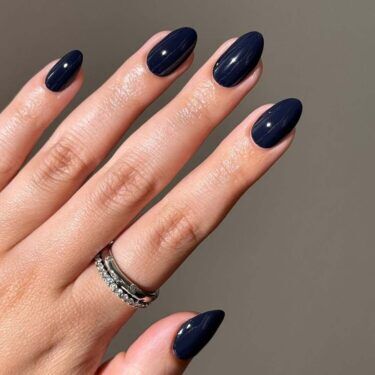 Manicure with dark navy polish.