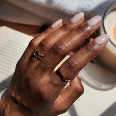 Short nails with light mauve, gray polish.