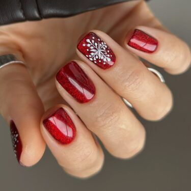Short red manicure with snowflake nail art