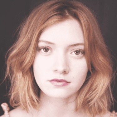 A portrait image of a a woman with collarbone-length hair