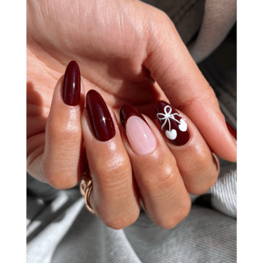 A close up of a woman's hands with her fingers folded into her palm to showcase her manicured nails