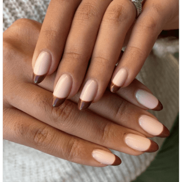 A close up of a woman's manicured nails