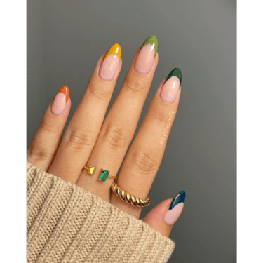 A woman's hand with her sweater sleeve covering most of her hands and her fingers exposed to showcase her manicured nails